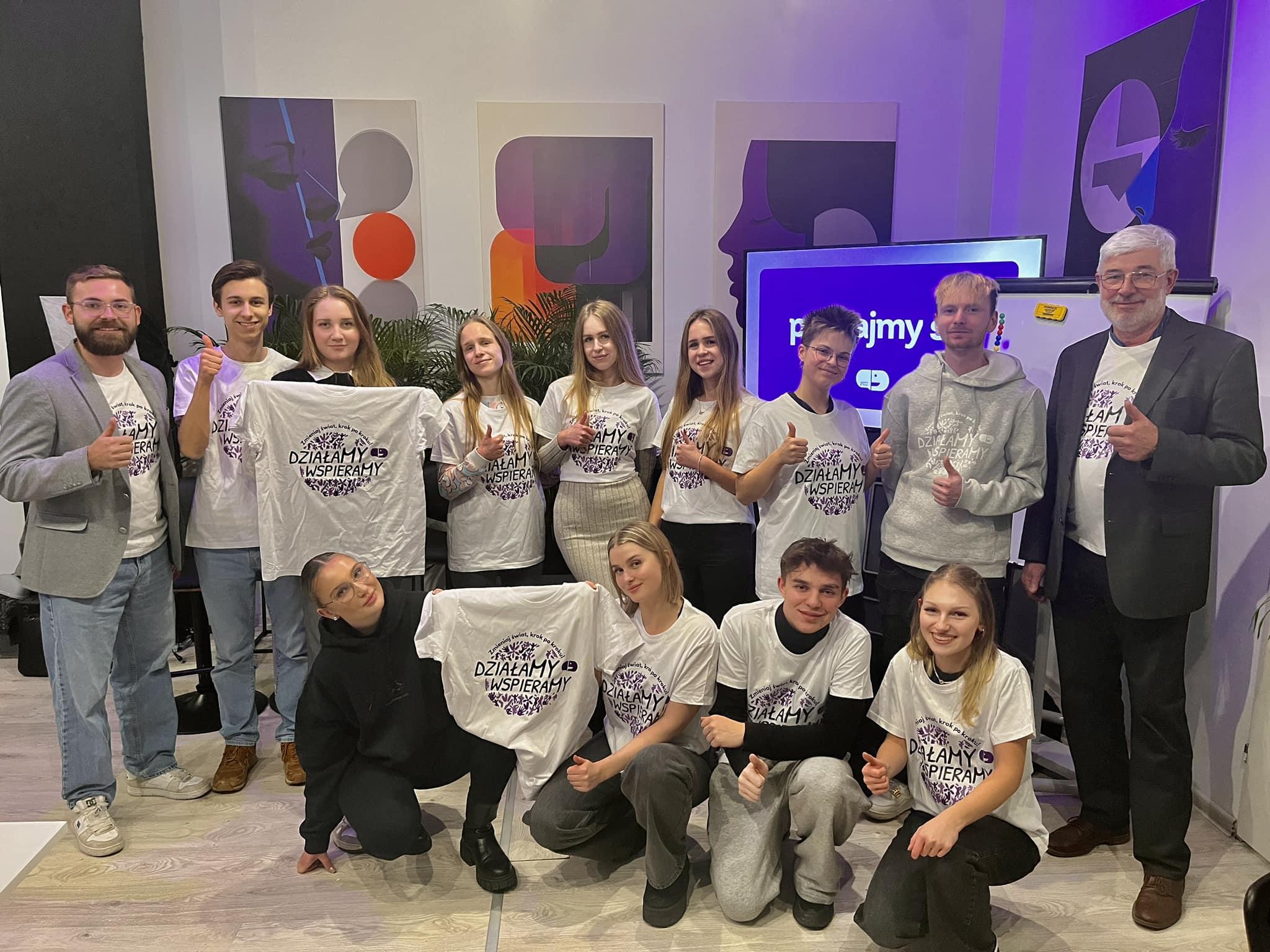 Young volunteers present project T-shirts during a meeting at SWT headquarters.