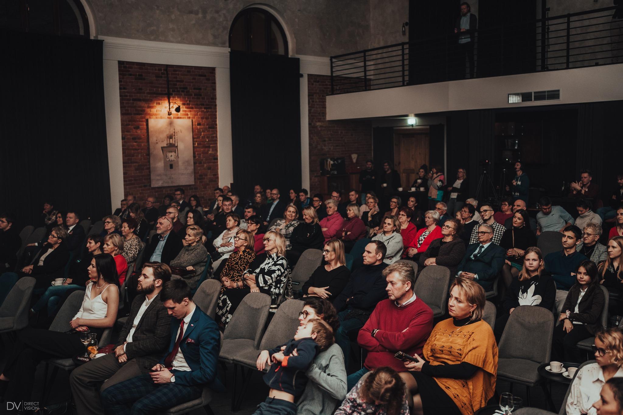 The audience sits in the auditorium during a concert in the event hall.