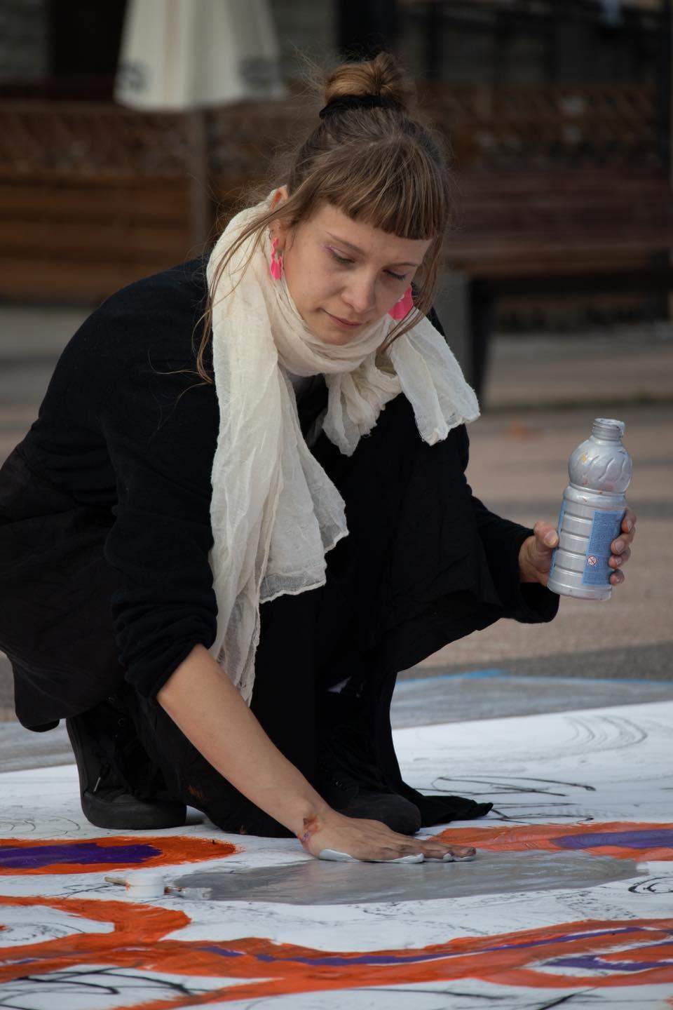 An artist creates a painting during an event carried out as part of the project.