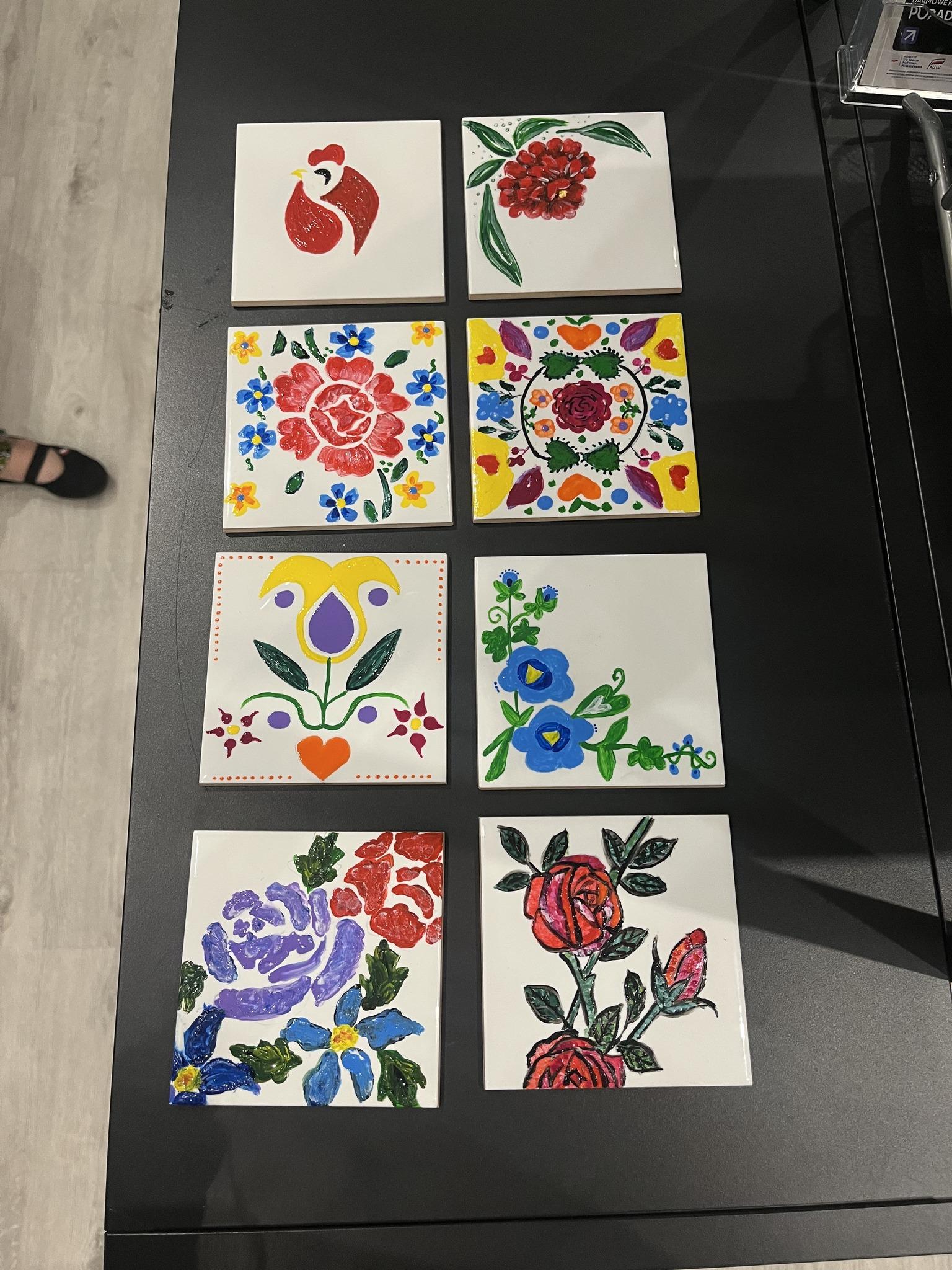 A group of participants presents completed embroidery or handicraft work during the workshop.